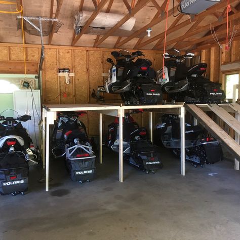 Garage Snowmobile Storage, Snowmobile Garage Ideas, Snow Sled Storage Garage, Pole Barn Accessories, Snowmobile Storage Rack, Atv Storage Ideas, Machine Shed Ideas, Snowmobile Garage, Snowmobile Storage