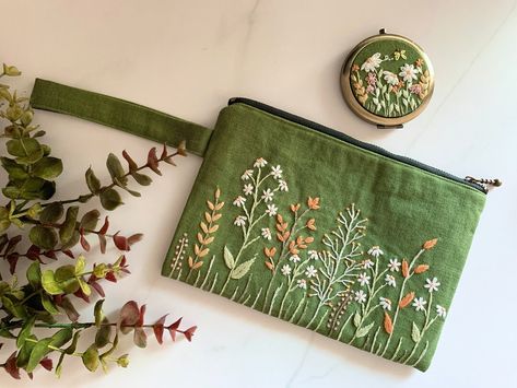 Buy Green Floral Hand-embroidered Clutch and Pocket Mirror online on Etsy India. Shop for handmade, vintage and unique Wedding Bags & Purses items from HANaCasChoice online on Etsy Embroidery Products Unique, Bridesmaid Embroidery Gifts, Embroidery On Pouch, Embroider Gift Ideas, Green Embroidered Tote Bag, Hand Embroidered Bag, Embroidered Makeup Bag, Hand Embroidered Gifts Ideas, Embroidery Gifts Ideas