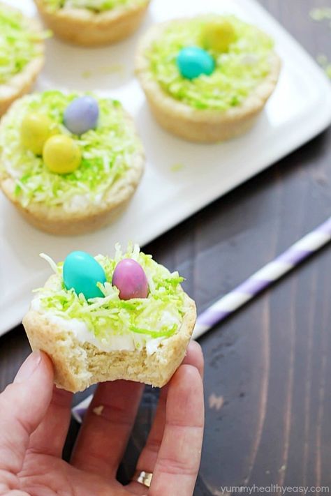 Need a fun treat to make for an Easter get together? Make these darling Easter Nest Sugar Cookie Cups! Sugar cookie dough cooked in a muffin tin, filled with vanilla frosting, topped with green tinted coconut and M&M eggs to look like a little bird's nest. So cute and great for spring! #truvia Easter Egg Nest, Cream Cheese Chicken Chili, Sugar Cookie Cups, Cookie Cups Recipe, Easter Nests, Easter Snacks, Easter Sugar Cookies, Cream Cheese Chicken, Sugar Cookie Dough