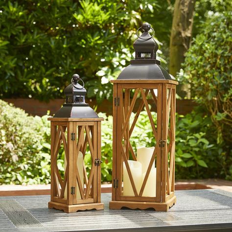 PRICES MAY VARY. [Sold as a set of 2 well sized] Each lantern measures as follows: the larger 9.00"L x 9.00"W x 28.75"H and the smaller 6.25"L x 6.25"W x 20.50"H. These lanterns ship in one box and the small lanterns are housed inside large lanterns. [Premium Material] The lantern made of fir wood and hand made finish,with diamond-shaped muntins on all four sides. A black metal top, brown swing latch and premium hinges connected. With its flame-retardant galvanized metal floor inside, They are g Decorate Lanterns Ideas, Large Outdoor Lanterns, Decorate Lantern, Lanterns Fireplace, Small Decorations, Antique Lanterns, Lantern Ideas, Large Lanterns, Small Lanterns