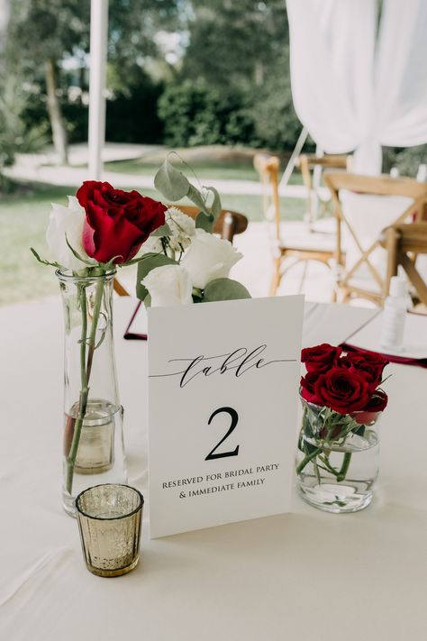 Red White Centerpieces Wedding, Romantic Dinner Centerpiece, Red Table Numbers Wedding, Elegant Red Rose Centerpieces, Minimalist Red Wedding Decor, Wedding Decor With Red Roses, Simple Red Centerpieces, Elegant Wedding Red Roses, Red And White Theme Wedding