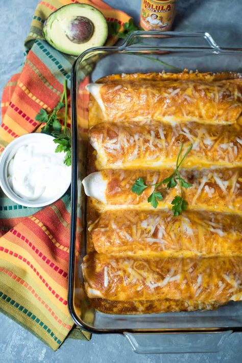 This Turkey Black Bean Enchilada Bake has a creamy, flavorful filling of lean ground turkey, black beans, corn, and diced tomatoes that is rolled in tortillas and topped with enchilada sauce and cheese. The recipe makes enough to feed a crowd or pop one dish in the freezer for an easy dinner when you need it! Turkey Enchiladas Healthy, Black Bean Enchilada Bake, Ground Turkey Enchiladas, Smothered Burritos, Enchiladas Healthy, Healthy Casserole, Turkey Enchiladas, Enchilada Ingredients, Enchilada Bake