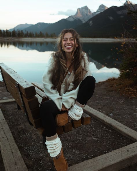 The best fall outfit ideas are the ones that are comfy, cozy, and cute! Here I’m wearing a neutral toned outfit, with a chestnut ugg tasmans, cream sherpa jacket, leg warmers, leggings, and long socks, in front of a mountain lake in Canmore!

Smile, photo inspiration, granola, girl, autumn, modest, curly long hair, layered hair, winter poses, pose ideas, bench, sitting, one leg up, tongue out, 202, 2024, eyes closed, reflection, natural makeup, casual date outfit three sisters Comfy Mountain Outfit, Lake Outfit Winter, Cute Winter Mountain Outfits, Mountain Date Outfit, Cozy Mountain Outfits, Nature Tone Outfits, Leg Warmers And Uggs Outfit, Cozy Cabin Outfit Winter, Long Leg Warmers Outfit