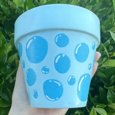 Embracing the beauty of blue bubbles in this lovely pot 💧🌿 . #BubbleArt #PotteryVibes #BlueHues #artistsoninstagram #claylove #instapost #daily #instadaily #post Painting Mini Terra Cotta Pots, Mini Terra Cotta Pot Paint, Hand Painted Terracotta Pots, Water Pot Painting Ideas, Mini Flower Pot Painting Ideas, Pot Painting Ideas For Kids, Flower Pot Painting Ideas Simple, Container Painting Ideas, Jar Painting Ideas Cute Easy