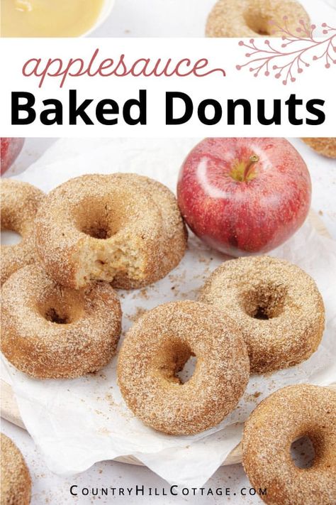 Delight your family and kids with baked applesauce donuts coated in crunchy cinnamon sugar! The easy apple donut recipe is a delicious fall treat and great for Thanksgiving brunch. Make a batch of these apple cinnamon donuts with just 7 ingredients in 30 minutes or less. They are soft and moist, super fluffy and perfectly spiced and easier than fried doughnuts. Serve these applesauce cake donuts for parties, potlucks, and whenever you need a cozy and comforting treat. | CountryHillCottage.com Applesauce Cake Donuts Baked, Apple Baked Donut Recipes, Applesauce Donut Recipe, Baked Applesauce Donut Recipes, Baked Apple Donuts With Donut Pan, Apple Sauce Donuts Recipe, Applesauce Donuts Baked, Apple Doughnuts Baked, Applesauce Ingredient Recipes