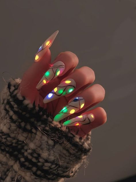 Celebrate the festive season with these unique light-up nails. Featuring a string of colorful lights painted onto a neutral background, this nail design adds a fun and playful touch to your holiday look. Perfect for spreading Christmas cheer with a modern, bold twist. Glow In The Dark Christmas Light Nails, Light Bulb Nails Christmas, Bold Christmas Nails, Holiday Light Nails, Lime Green Christmas Nails, Christmas Nails Abstract, Christmas Lights Nails Design, Christmas Lights Nail Art, Simple Festive Nails