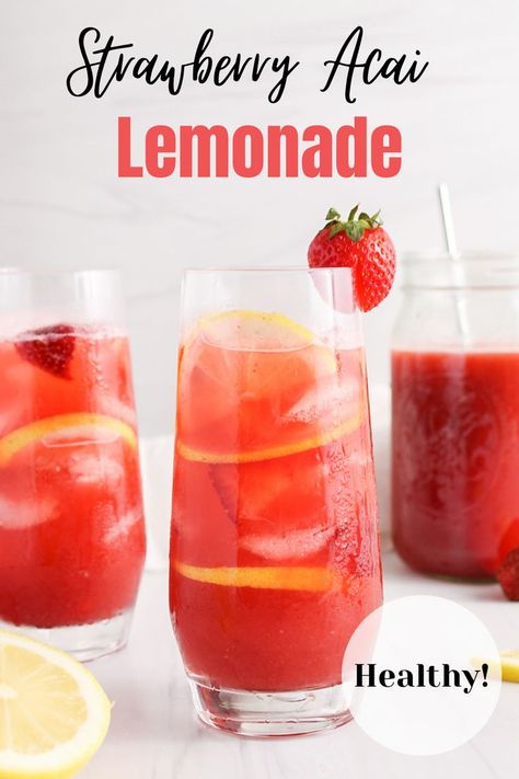 Front view on a tall glass filled with a strawberry acai lemonade refresher with ice cubes, fresh strawberries and lemon slices. There are more of the lemonade in a large pitcher in the background and a second glass on the side as well. There are halved lemon beside the glasses too. Starbucks Strawberry Acai Refresher With Lemonade Recipe, Starbucks Strawberry Açaí Lemonade, Starbucks Strawberry Acai Lemonade, Lemonade Refresher Starbucks, Strawberry Acai Lemonade Refresher, Strawberry Refresher Recipe, Strawberry Açaí Lemonade, Strawberry Acai Lemonade, Acai Lemonade