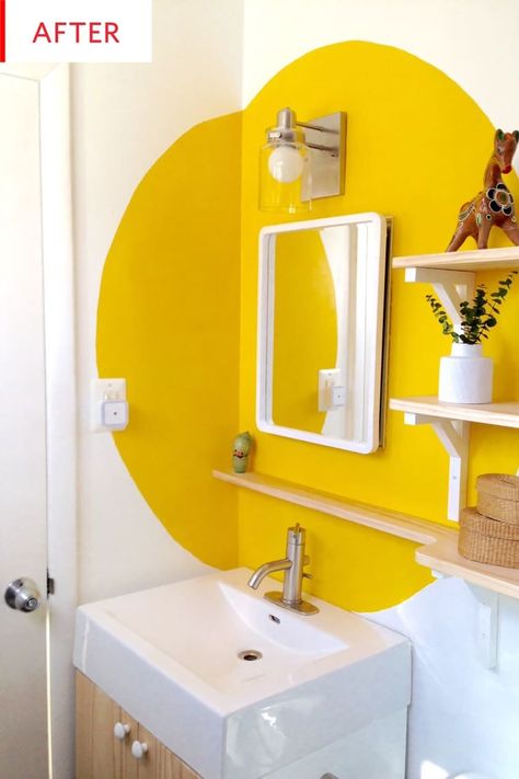 This bathroom makeover only cost $130. We love the new shelving, mirror and especially the unique paint color and design. This is proof that you can transform your bathroom on a budget. Colour Blocking Bathroom, Colorful Bathroom Paint Ideas, Colorful Entryway Ideas, Paint In Bathroom, Yellow Bathroom Paint, Eccentric Bathroom, Colorful Bathroom Ideas, Colorful Bathroom Decor, Unique Paint Colors