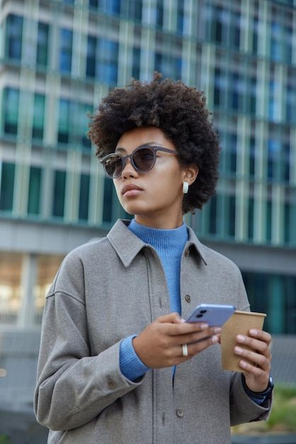 Attractive young curly haired woman wear... | Free Photo #Freepik #freephoto #woman-phone #people-with-phone #people-with-smartphone #using-mobile Person Looking At Phone, Phone Lifestyle, Blind Girl, Ux Inspiration, Studio Website, People Having Fun, Reference Pics, Drinks Coffee, Brand Shoot