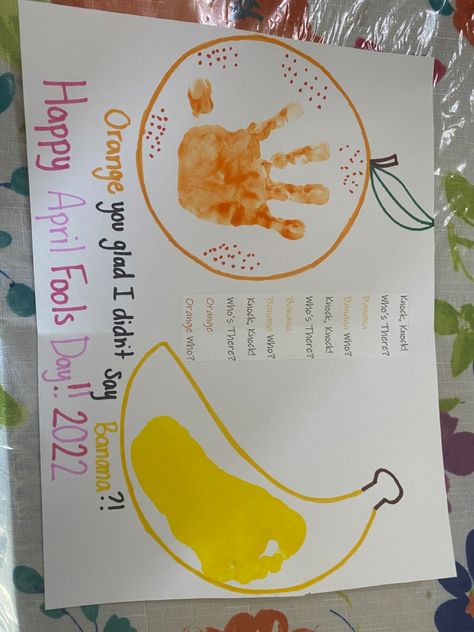 Yellow outline of a banana with a child’s yellow footprint in the middle. Orange outline of an orange with a child’s orange handprint one the middle. A typed knock knock joke glued in-between the orange & the banana. Underneath the orange & the banana handwritten punchline “orange you glad I didn’t say banana?!” with the orange written in orange sharpie & the banana written in yellow sharpie. Underneath the written punchline, handwritten in purple & pink sharpie is “Happy April Fools Day!! 2022” April Fools Toddler Craft, April Fools Art Projects For Kids, Easter Artwork For Infants, April Lesson Plans For Infants, April Fools Crafts For Infants, April Fools Arts And Crafts, April Fools Crafts For Toddlers, April Fools Day Craft, April Art Projects For Infants