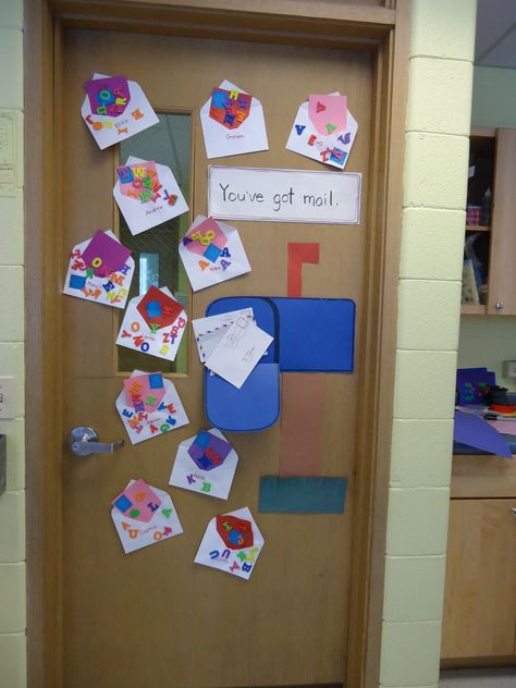 Post office themed bulletin board on the classroom door.  We like to make use of all of out space to create bulletin boards out of the children's art. Post Office Bulletin Board Ideas, Post Office Math Activities Preschool, Classroom Post Office, Community Helpers Week Preschool, Post Office Art Preschool, Post Office Preschool Crafts, Post Office Crafts For Toddlers, Post Office Activities For Toddlers, Post Office Theme Preschool