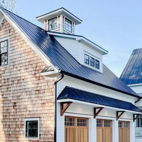 George | The DIY Warrior on Instagram: "Cedar shakes are the little black dress of exterior design.   Let’s also not forget about these beautiful Cedar Full Overlay garage doors by chioverheaddoors #chioverheaddoors   #cedar #cedarshakes #cedarshake #metalroofing #metalroof #jameshardie #chantillylace #coupula #newbuild #newbuildhome #newconstruction #newhome #waterfront #warerfronthomes #brickwork #newconstructionhomes #carolinahomes #coastalvibes #coastalfarmhouse #coastalliving #waterfrontrealestate #farmhouse #modernfarmhouse #moderndesign #exteriorhome #homegoals #housegoals #peepmypad #cljsquad" Cedar Shake Farmhouse, White House With Cedar Shake Accents, Cedar Shake And Board And Batten Siding, Cedar Shakes On Gables House, House Gables Exterior, Brick And Cedar Shake Exterior, White House Black Roof Wood Accents, White And Cedar House Exterior, Cedar Shake Siding Accent