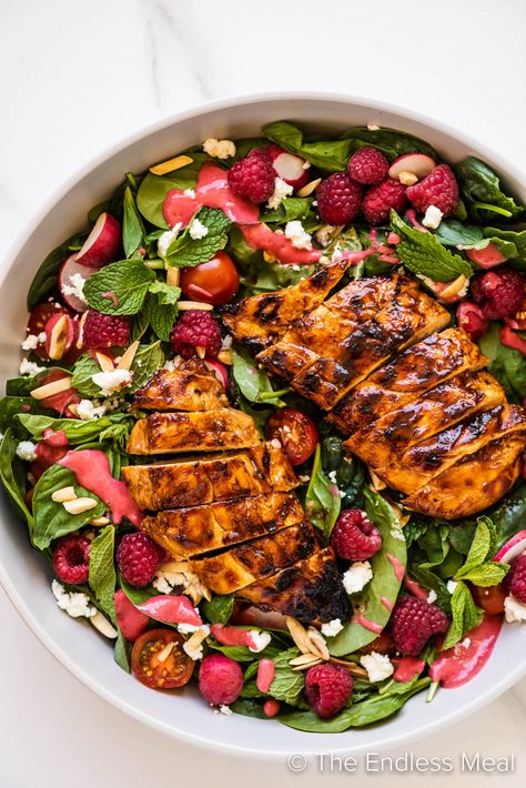 This summer chicken salad with raspberries celebrates the best of the season. It's juicy BBQ chicken served on a bed of spinach with fresh herbs and creamy goat cheese then drizzled with a tangy-sweet raspberry dressing. It's simple to make (without turning on the oven), and it's ready in just 20 minutes! #theendlessmeal #salad #healthysalads #dinner #lowcarbdinner #healthydinner #chickenrecipe #chickendinner #healthyrecipes #summersalad #summerchickensalad #raspberries Salad With Raspberries, Summer Chicken Salad, Raspberry Dressing, Raspberry Chicken, Raspberry Salad, Grilled Peach Salad, Summer Chicken, Grilled Corn Salad, Creamy Goat Cheese