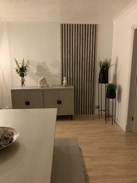 Grey Wood Slat Wall, Wood Lines Wall, Vertical Panelling Living Room, Partial Slat Wall, Slat Wall Dining Room, Slat Wall Ideas Living Room, Grey Slat Wall, White Slat Wall, Vertical Wood Slat Wall