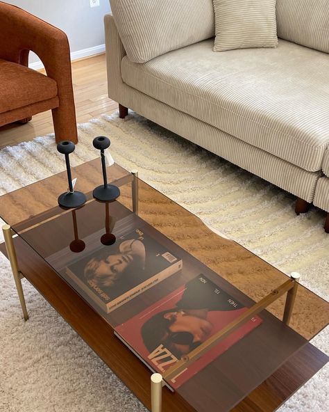 Stylish and durable coffee table with a chic design featuring a coffee brown glass top, walnut finish wood shelf, and gold-finished steel frame for stability. Perfect for living rooms, office lounges, or stores, this 43"x24"x16" table adds a luxurious touch to any space. Amber Glass Coffee Table, Living Room With Glass Coffee Table, Sofa And Coffee Table Ideas, Brown Glass Coffee Table, Coffee Table And Tv Stand Ideas, Green Accent Chair Living Room, Art Deco Lounge Room, Small Coffee Table Decor, Creative Coffee Table Ideas