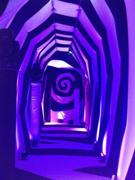 Alice in Wonderland Christmas Event by Creative Draping www.creativedraping.com Creepy Wonderland Aesthetic, Alice In Wonderland Spiral, Purple Circus Aesthetic, Neon Alice In Wonderland, Alice Rabbit Hole, Alice In Wonderland Tunnel, Alice In Wonderland Set Design, Alice In Wonderland Christmas, Neon Wonderland