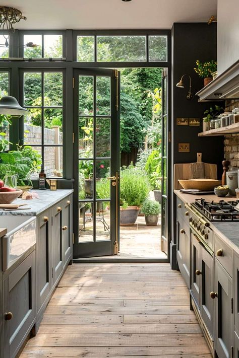 Greenhouse Inspired Kitchen, Kitchen Connected To Garden, Glass Enclosed Kitchen, Crittal Doors Extension Kitchen, Kitchen Opens To Patio, Atrium Kitchen Extension, Greenhouse Connected To Kitchen, Kitchen With Doors To Outside, Kitchen Leading To Patio