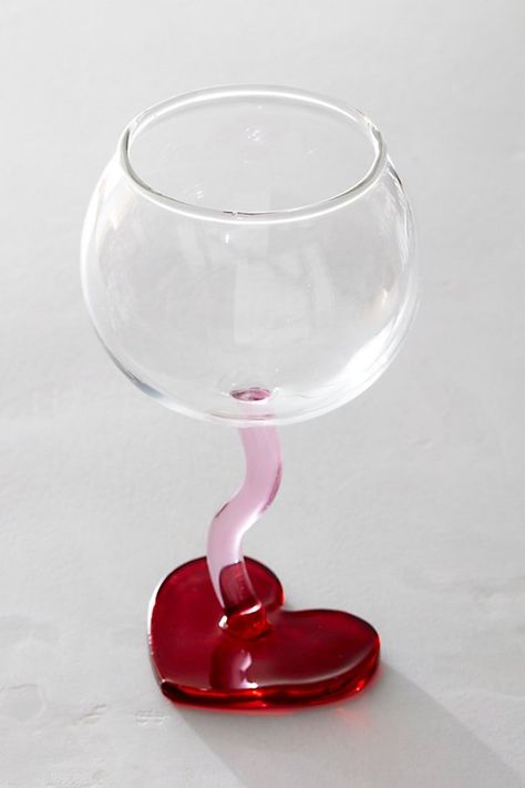 Take your drinkware up a notch with this super sweet wine glass with a squiggly stem and contrasting heart-shaped bottom for added dimension. **Features:** Round bowl top, squiggly stem, heart-shaped bottom **Why We ❤ It:** Sip sweetly with this stunning wine glass, designed to add a little something extra to any bar cart collection. | Heart Stemmed Wine Glass at Free People in Red Cute Wine Glasses, Fun Wine Glasses, Flat Decor, Vintage Wine Glasses, Cute Furniture, Sweet Wine, Pinterest Room Decor, Pretty Drinks, Red Decor