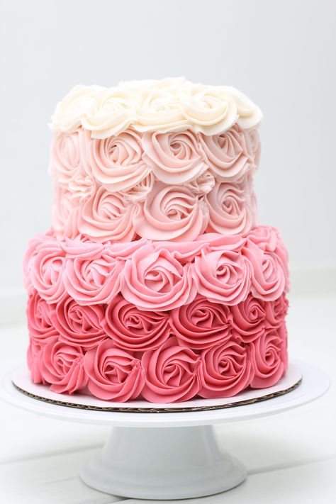 This is a 2 tier pink rose ombré cake covered in buttercream icing💗 Pink Rosette Cake 2 Tier, Pink Ombre Rosette Cake, Pink Roses Birthday Theme, Ombré Rosette Cake, Pink 2 Tier Birthday Cake, 2 Tier Rosette Cake, 2 Tier Pink Cake, Two Tier Pink Cake, 2 Tier Buttercream Cake