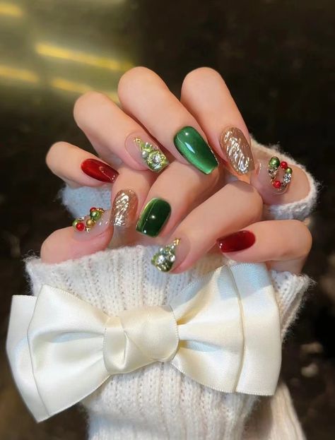 The red and green combination creates a striking mix, with a bold color scheme that delivers a visually arresting effect. The manicure features Christmas tree and wreath elements and the overall design is harmonious. This manicure has cat eye and matte effects, with shiny red, green and gold colours that give it a Christmassy feel. I love it.#Christmas#manicure#share Red Green And Gold Christmas Nails, Red And Green Combination, Gold Sparkle Nails, Red And Gold Nails, Green Combination, Gold Nail Designs, Christmas Manicure, Red Christmas Nails, Cute Christmas Nails