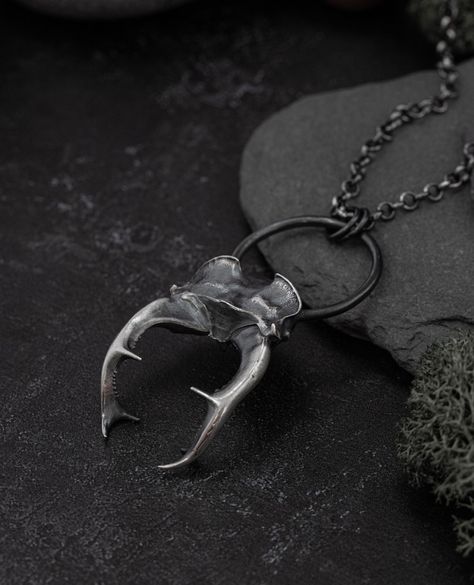 What do you think of this unusual talisman? ⁠ ⁠ This is one of my favourite designs - Thunor, a Stag Beetle cast in solid silver and hung from a circle. It looks stunning with a chunky belcher chain. The pairing of the natural textures and geometric shapes makes this a statement talisman and a powerful ode to the wilds. ⁠ ⁠ Call on the Stag Beetle when in need of:⁠ ⁠ Inner strength⁠ Resilience⁠ Weathering storms⁠ Renewal ⁠ ⁠ Explore this talisman by following the link in my bio. Artificer Dnd, Beetle Necklace, Shadow Side, Necklace Tattoo, Dark Forest Aesthetic, Gothic Jewellery, Forest Aesthetic, The Stag, Dark Nature