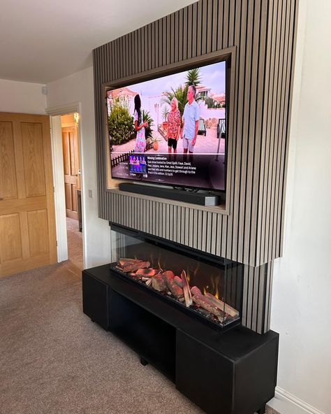 💎 Another of this week's media wall installations - this time featuring a standalone up-and-down build, a black base with cupboards for storage, our LUMIERE 1270mm electric mediawall fire, light wood slat, and a deep TV recess with room for a soundbar on the shelf. OUR SHOWROOM ✅ See before you buy ✅ Huge brick-and-mortar showroom ✅ 400+ fires and 60+ mediawalls on live display ✅ Specialist advice ✅ Showroom exclusive brands ❗️Pricing for mediawalls is bespoke to you, your needs and your bu... Recessed Tv Wall, False Wall, Wall Fires, Wall Cupboard, Decor Fireplace, Living Room Decor Fireplace, Wood Fireplace, Media Wall, On Live