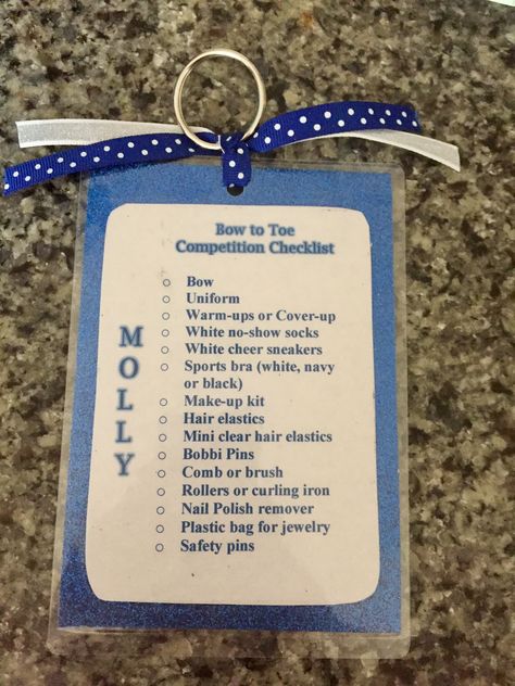 Bag tag/checklists for my daughter's cheer team. Made using paper, 4x6 thermal laminator pouches, key rings and ribbon. Cheer Bag Tag Ideas, Cheer Gift From Coach, Competitive Cheer Gifts For Team, Cheer Competition Checklist, Color Guard Team Bonding, Cheer Comp Checklist, Cheer Bag Checklist, Team Gifts Cheerleading, Dance Team Bonding Ideas