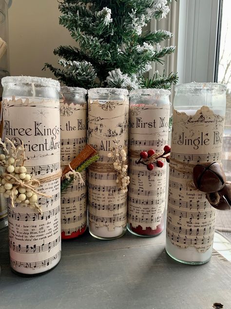 Please see below for colors, add your request in the personalization note. These 8in tall candles are perfect for your holiday decor! Choose between 7 vintage sheet Christmas music types and varying colors. The sheet music is hand dyed and encrusted on the candles and every strung on addition is specifically curated to add on extra pizazz to each candle. Deck The Halls - 2 Red First Noel - 1 Red Away in a Manger - 1 Red Jingle Bells - 2 White 3 Kings - 1 White Silent Night - 2 Red O Come All Ye Sheet Music Christmas Crafts, Sheet Music Decorations, Diy Christmas Candles Decorations, Christmas Pillar Candles, Country Christmas Centerpieces For Table, Christmas Decor Candles, Christmas Tea Table Decorations, Christmas Crafts Candle Holders, Advent By Candlelight Table Ideas