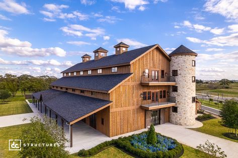 This custom wedding venue in Bryan, Texas is one of the largest commercial projects ever designed by DC Structures. Based on our Legacy Event Barn Kit, this 15,755 sq. ft. venue offers nearly three times the conditioned floor area of our original building model, with three levels dedicated to wedding day preparation. The first floor features a 6,133 sq. ft. main hall that opens to the third story, creating a truly stunning interior with dramatic vaulted ceilings and custom chandeliers. Three Story Barndominium, 5000 Sq Ft Barndominium, Building Wedding Venue Ideas, Massive Barndominium, Event Barn Floor Plans, Party Barn Floor Plans, Event Venue Floor Plan, Barn Venue Floor Plans, Pole Barn Wedding Venues