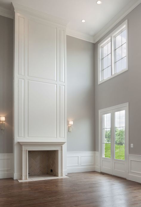 Tall Paneled Wall, Two Story Tv Wall, Fireplace 2 Story, Two Story Paneled Wall, Wall Paneling Tall Ceiling, Fireplace Two Story Living Room, 2 Story Fireplace Decor, Tall Wall With Fireplace, Two Story Wainscoting