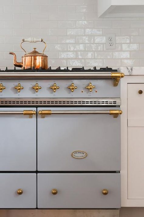 A stunning gray Lacanche stove accented with a brass trim sits against white subway backsplash tiles beside white cabinets topped with a honed white marble countertop. Lacanche Stove, Nantucket Interior Design, French Farmhouse Kitchen, Kitchen Remodel Countertops, Kitchen Countertop Materials, Brass Trim, White Marble Countertops, Home Luxury, Up House