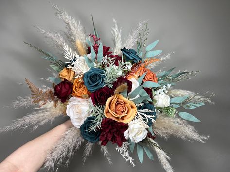 We are a Full Service Florist 💐 That means that we can make and customize anything!💕 Every single item in your order will be matched to the same style as the Bridal Bouquet on the photo, unless you ask otherwise.🥰 You can customize any item (size, color, flowers, accents) or we can make items that are not even listed For example you can request groom's boutonniere to stand out from the rest of them 🤗 We will be sending you photos of all the items for confirmation! Nothing gets shipped unless Dark Teal Wedding Bouquet, Dark Teal And Rust Wedding, Wedding Dark Teal, Dark Teal And Rust Orange Wedding, Orange And Blue Wedding Colors, Terracotta Bridesmaids, Teal Fall Wedding, Bridesmaids Burgundy, Burnt Orange Bouquet