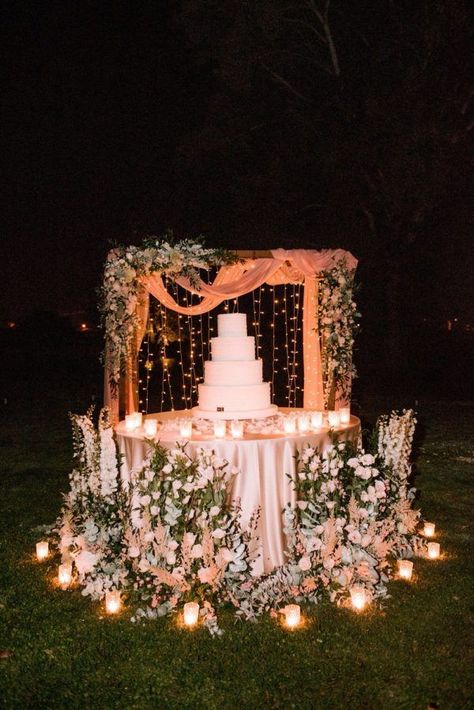 wedding cake display surrounded by flowers Wedding Flower Display Ideas, Romantic Wedding Cake Table, Outdoor Wedding Cake Table Ideas, Simple Cake Backdrop, Unique Wedding Cake Display, Cake Tables Wedding, Outdoor Wedding Cake Table, Cake Displays For Weddings, Wedding Cake Display Table Elegant