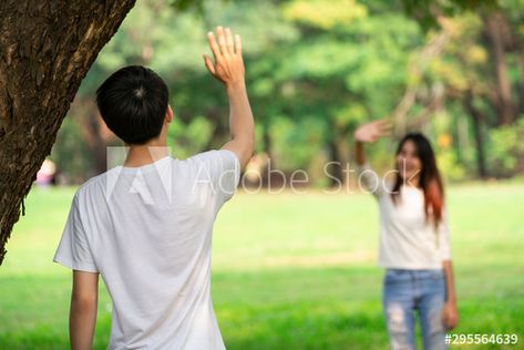 Stock Image: Young people, man and woman greeting or saying goodbye by waving hands in the park. Saying Goodbye, His Hands, Clue, The Park, Stock Images, Stock Photos, Men And Women, Mens Tshirts