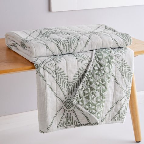 The Kemala Sage Reversible Throw by Levtex Home is inspired by ornate medallion tiles. Offered in sage and cream, this design will immediately transform any room in your home. This throw features tiled sage medallions with leaves on a cream background on the front, reversing to a small sage medallion on a cream ground on the back. The Throw (50x60in.) has a cotton front and back, filled with a cotton-rich filler, and is machine washable. Enjoy this for years to come! Sage Bedroom, Green Throw Blanket, Quilted Throw, Quilted Throw Blanket, Cozy Chair, Green Throw, Holiday Quilts, Feature Tiles, Weaving Textiles