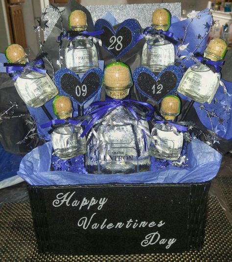 Liquor arrangement! #patron #tequila #blue #black #basket #valentines #gift for him Patron Gift Basket For Men, Patron Gift Basket Ideas, Liquor Baskets, Liquor Basket, Valentines Day Basket, Miniature Bouquet, Beer Cakes, Alcohol Bottle Decorations, Liquor Bouquet