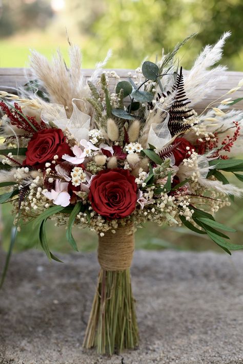 This unique bouquet has: ❤️ Premium High Quality Flowers ❤️ %100 Dried and Preserved Flowers  ❤️ No Fake Flowers... ❤️ Free form ❤️ 8 Rose Color Options (You can DM also for other options) ❤️ Many Matching items for Bride, groom, bridesmaids and family  ❤️ Many Matching items for Wedding Decor The bouquet has a form that expands to the sides. While most wedding bouquet shapes tend to be more vertical in nature, freeform bouquets are often more horizontal, are loosely tied with gorgeous ribbon and often incorporate gorgeous greenery, a wide variety of flowers with varying stem lengths, and are perfectly imperfect - purposefully asymmetrical and imbalanced. It will perfectly harmonize with bohemian-romantic wedding dresses. Its soft color is quite attractive for brides. An elegant, natural a Bouquet Shapes, Dried Bridal Bouquet, Boho Bridal Bouquet, Red Bridal Bouquet, Prom Bouquet, Red Bouquet Wedding, Red Bouquet, Romantic Bouquet, Unique Bouquet