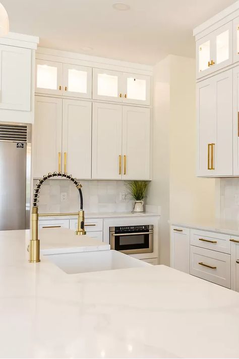 This bright kitchen features white cabinets with gold hardware for a touch of luxury. The butcher block countertops add warmth and contrast, while the open shelving keeps dishes and cookware on display. #kitchen #kitchendesign #whitekitchen #goldhardware #butcherblockcountertops #openshelving #kitcheninspo #dreamkitchen #homedecor #interiordesign #whiteandgold #kitchenmakeover #instahome #homestyling #kitchendecor #luxurykitchen #warmkitchen White Kitchen With Black And Gold Hardware, Kitchen Ideas With Gold Accents, White Kitchen Cabinets With Gold Pulls, Gold Accents In Kitchen, White And Gold Kitchen Cabinets, Kitchen White Cabinets Gold Hardware, White Cabinets Gold Handles, White Kitchen Cabinets With Gold Handles, White Kitchen Gold Hardware