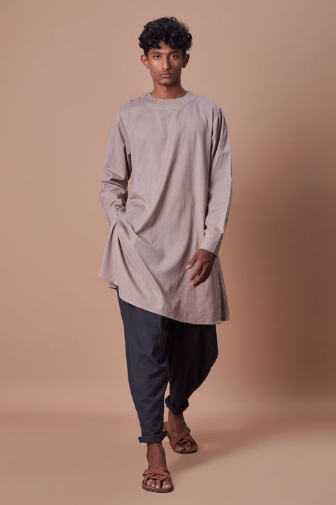 Grey handwoven short kurta with asymmetric button placket and cuff sleeves. Paired with balloon pleated pant. Component: 2 Pattern: Plain Neckline: Round Sleeve Type: Cuff Sleeves Fabric: 100% Cotton Color: Grey Other Details:  Asymmetric placket Cuff sleeves Occasion: Puja - Aza Fashions Pleated Pant, Short Kurta, Eco Friendly Clothing, Clothing Material, Ethical Clothing, Pleated Pants, Sustainable Clothing, Cuff Sleeves, Button Placket