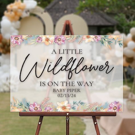 Capture the spirit of whimsy and natural beauty with our enchanting acrylic welcome sign, adorned with the heartfelt message "A little Wildflower is on the way." This exquisite piece of event décor is designed to infuse your baby shower with a sense of wonder and celebration. The phrase "A little Wildflower is on the way" speaks to the unique and untamed spirit of the precious new addition to your family, embodying the joy and anticipation of welcoming a little one into the world. This personali Baby In Bloom Chalkboard Sign, A Little Wild Flower Is On The Way, Wild Flower Baby Shower Ideas Decoration, A Little Wildflower Baby Shower Theme, A Wildflower Is On The Way, A Little Wildflower Is On The Way Decor, Floral Baby Shower Ideas Decoration, Little Wildflower Baby Shower Decor, A Little Wildflower Is On The Way