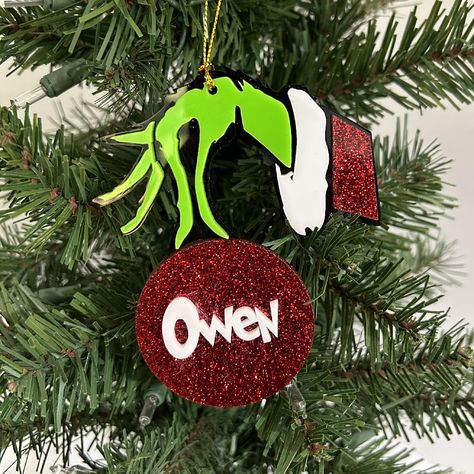 PRICES MAY VARY. Personalize this ornament with choice of name Measures approx. 3.5" x 4.5" Material - acrylic Comes with a hanging gold cord for easy hanging on the tree Introducing our personalized Grinch Christmas Ornament, perfect for decorating your Christmas tree and adding a touch of cuteness to your festive decor! Key Features: hand holding a personalized Christmas ornament. Comes with a gold cord for easy hanging on the tree Personalized with one name. This classic style ornament is an Grinch Tree Ornaments Diy Christmas, Personalized Grinch Ornaments, Grinch Christmas Tree Ornaments, Grinch Christmas Ornaments Diy, The Grinch Ornaments, State Christmas Ornaments, Grinch Ornament, Grinch Stuff, Grinch Hand