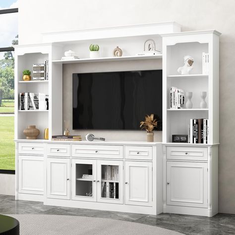 PRICES MAY VARY. Dimensions: The TV console: 57.2”W x 17.4”D x 30.5”H, the wall mounted bookshelf on the top: 69.1”W x 10.7”D x 8.7”H, the bookcase: 23.5”W x 10”D x 77.2”H, overall dimensions of the entire unit: 104.3”W x 17.4”D x 77.2”H-82.3”H, all of the dimensions are adjustable. NOTE: The entire unit will come in 3 boxes separately. Modern Design: This ECACAD white TV stand unit with glass doors is minimalist, the entire wall unit with carved legs will create luxury charm. It works well in l Tv Stand With Bookshelves, Ikea Entertainment Center, Wall Unit Tv, Entertainment Center Wall, Wall Units With Fireplace, White Tv Cabinet, Tv Stand Bookshelf, Old Entertainment Centers, Tv Stand Unit