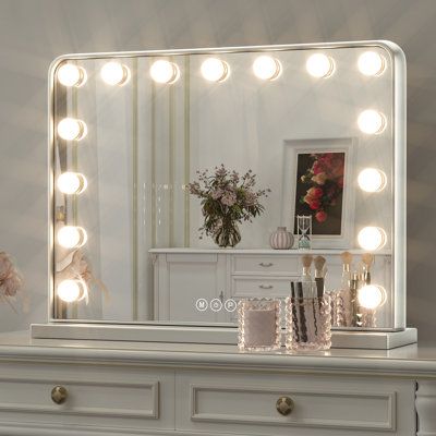 This lighted Hollywood mirror brightens any space with its built-in LED lights. It boasts a rectangular silhouette that works horizontally. This mirror has a metal frame that features curved corners and beveled edges for a retro, vintage-inspired feel. It's rated for damp or dry environments, working equally well in your bedroom, bathroom, or powder room. The included LED bulbs are dimmer-switch compatible for creating the right ambiance, day or night. Size: 18" x 23", Finish: Silver | House of White Vanity Mirror, Light Up Vanity, Hollywood Mirror With Lights, Hollywood Makeup Mirror, Makeup Lighting, Vanity Makeup Mirror, Hollywood Vanity Mirror, Hollywood Vanity, Makeup Light