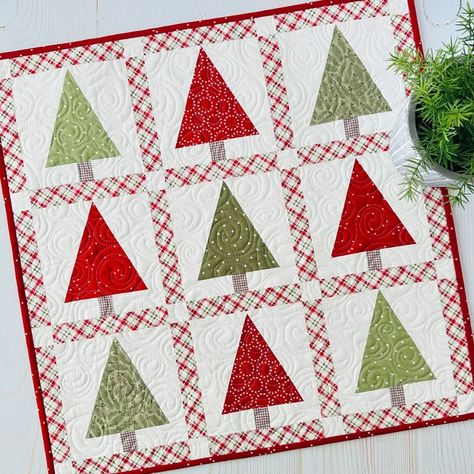 **NEW!!** Tree Mini!! This fun little tree mini will have your halls decked in no time!  Simple to make with traditional piecing.  No templates or special rulers.  I hope you love it! Finished size is 22” x 22”.  Kit includes the backing and can be purchased with or without our newest pattern, Mini Celebrations! It includes five seasonal minis. Paper and PDF patterns available. Tap link in profile to shop or visit our website SweetDaisyQuiltShoppe.com 📷Sweet Daisy Quilt Shoppe . . #... Christmas Quilted Table Runners Patterns, Christmas Tree Quilts, Christmas Present Quilt, Quilts Christmas, Daisy Quilt, Tree Quilt Block, Suzy Quilts, Christmas Table Toppers, Christmas Tree Quilt