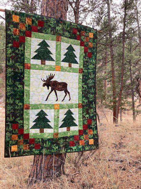 "A moose meanders through the pine trees in this quintessential forest quilt. This is an original pattern - you won't find it anywhere else! This pattern:  - Makes a throw size quilt - 45\" x 63\"   - Is perfect for a wall hanging or couch throw  - includes fabric requirements  - Includes detailed illustrations  - Includes step-by-step instructions for ¼\" piecing and fusible appliqué  - Includes all necessary templates  - Is suitable for the experienced beginner This pattern is a digital downlo Quilt Beginner, Moose Quilt, Canadian Quilts, Blue Quilt Patterns, Throw Size Quilt, Wildlife Quilts, Forest Quilt, Tree Quilts, Panel Quilt Patterns