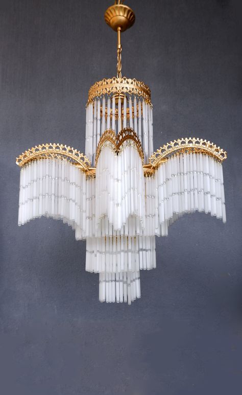 This beautiful chandelier lamp will make a statement in your home and gives a beautiful effect. This lamp was most likely made in Turkey. The sticks are hollow glass. They make a gentle sound if they get caught in a breeze. The lamp is white with gold, it is pictured with warm-colored light bulbs hence the change of color, it would stay white with white light bulbs. It is 35 1/2'' (90 cm) high and has a diameter of 23'' (45 cm) wide, a great piece for a room with a high ceiling. This is a vintage piece and might show small damages and patina,  but all in all in great vintage condition. Works with 5 E14 and 1 E27 lightbulbs. Please note that the glass sticks will be removed for safe shipment, they are very easy to reattach but it will be quite a a bit of a task as there are 445 sticks, this Art Deco Apartment Living Room, White And Gold Room Aesthetic, 1920s Light Fixtures, Stick Chandelier, Chandelier Art Deco, Cool Chandeliers, Fringe Chandelier, Colored Light Bulbs, Chandelier White