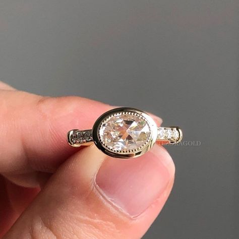 East West Oval Cut Colorless Moissanite Pave Set Milgrain Engagement Ring, Bezel Set Wedding Ring, Art Deco Ring For Women, Yellow Gold Ring, Vintage Ring, Diamond Ring, Handmade Ring, Promise Ring ✥ 𝗗𝗲𝘀𝗰𝗿𝗶𝗽𝘁𝗶𝗼𝗻 𝗢𝗳 𝗥𝗶𝗻𝗴 :- ✥ Moissanite Diamond Details :- * Center Stone Shape :  𝐎𝐯𝐚𝐥 𝐂𝐮𝐭 * Center Stone Weight : 𝟏.𝟐𝟓 𝐂𝐓 * Center Stone Measurement : 𝟖.𝟎𝟎*𝟔.𝟎𝟎 𝐌𝐌 * Side Stone Shape : 𝐑𝐨𝐮𝐧𝐝 𝐂𝐮𝐭 * Side Stone Weight : 𝟎.𝟐𝟓 𝐂�𝐓𝐖 * Stone Color : Colorless Bezel Set Wedding Ring, Engagement Ring Bezel, Moissanite Wedding Set, Milgrain Engagement Ring, Wedding Ring Art, Gold Vintage Ring, Rose Gold Ring Set, Ring Bezel, Halo Style