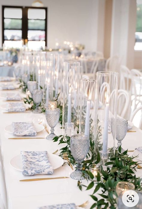 Blue Candles Wedding Table, Coastal Candle Centerpieces, Blue And White Candle Centerpiece, Clear Glass Wedding Table Decor, Blue And White Candle Centerpieces, Wedding Ideas White And Blue, Light Blue Greenery Wedding, Vintage Blue Table Setting, Light Blue Tablescape Wedding