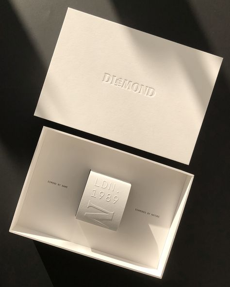 Custom box with platform made for Dimond London Design by Coralie Carre Blind debossing on the lid, black foil stamping inside and outside bottom lid. Blind embossing on the inner box sleeve. Paper: 2mm White Sumo Board Favini Papers #packaging #rigidbox #jewellerypackaging #lidandtrayboxes #packagingdesign ##packaginginspiration #embossing #debossing Fashion Box Packaging, Fashion Business Cards Creative, High End Packaging, Debossed Business Card, Rigid Box Packaging, Mailer Box Design, Custom Mailer Boxes, Jewelry Packaging Design, Embossed Business Cards