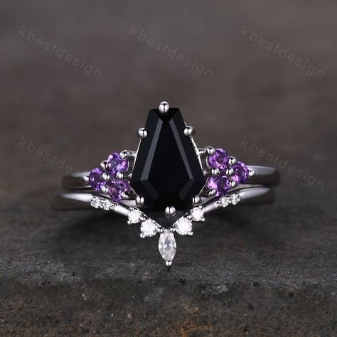 This is a beautiful black onyx and Amethsyt engagement ring set in sterling silver. Sterling Silver Black Onyx Engagement Ring Set Unique Coffin Shaped Ring Art Deco Moissanite Curved Wedding Band Amethyst Cluster Ring Unique coffin shaped ring, wedding ring, promise ring, anniversary gift. Engagement ring: Main Stone: 9x6mm coffin shaped black onyx. Side stone: 2mm amethyst Wedding band: Curved Moissanite This ring is marked S925/G10K/G14K I accept custom making order.Please contact me if you n Goth Ring Sets, Goth Engagement Rings Fairy, Black Coffin Engagement Ring, Black And Purple Engagement Ring, Coffin Wedding Rings, Coffin Shaped Ring, Coffin Ring Engagement, Black And Purple Wedding Rings, Goth Promise Ring